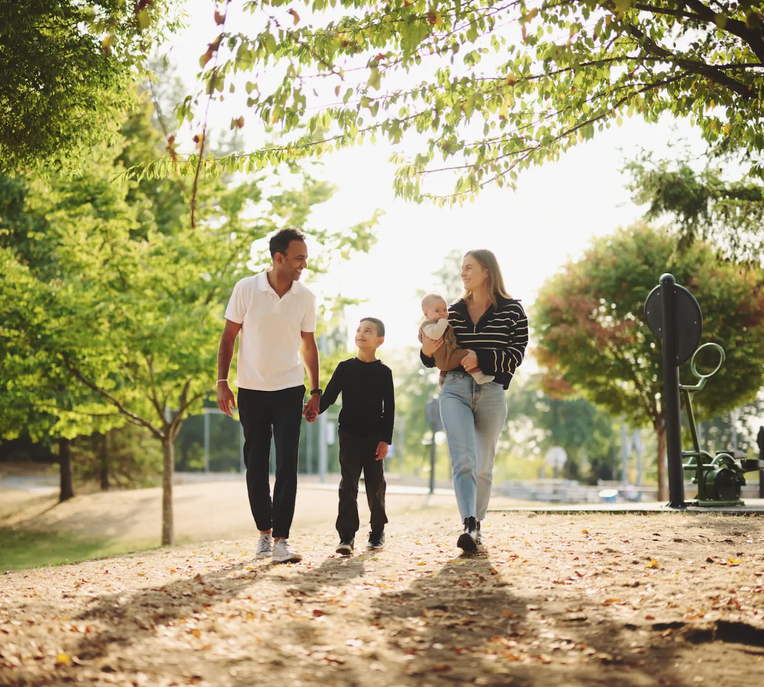 A family walking a tree-lined street in West Coquitlam